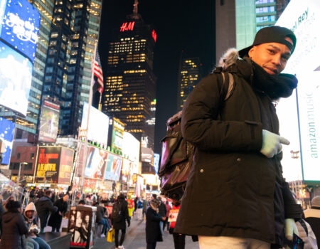 Rawy Sanz stands in Times Square, Manhattan.