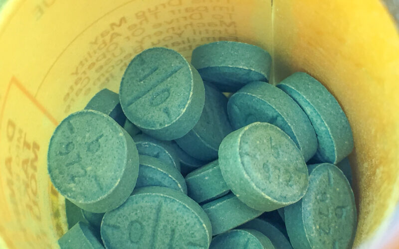 Adderall pills are shown in a bottle.