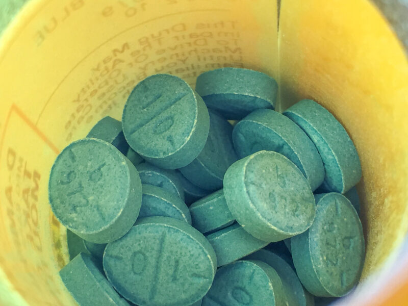 Adderall pills are shown in a bottle.