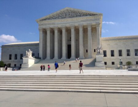 The Supreme Court Building is shown on a sunny day.