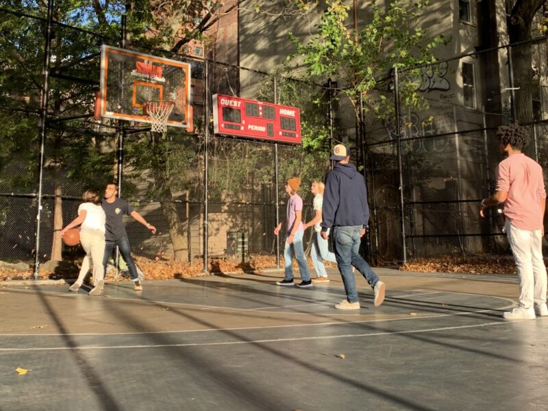 People play basketball at The Cage.