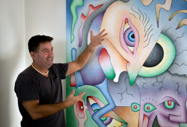Golub explains his art on the wall. It is one of his earlier works. Credit: Elena Luwa Yin.