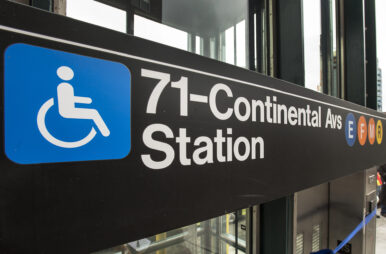 A sign for the Forest Hills-71st Avenue stop highlights accessible elevators.