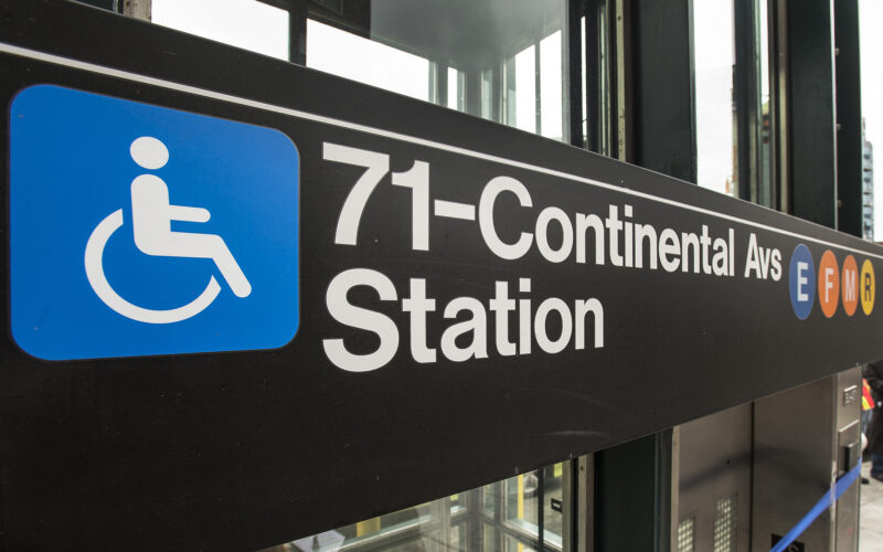 A sign for the Forest Hills-71st Avenue stop highlights accessible elevators.