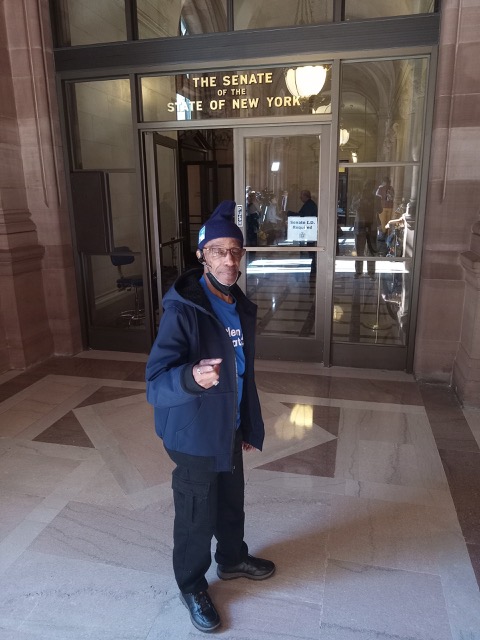 Victor Pate stands outside of the senate chambers of the state of New York to lobby for criminal reform. (Credit: Victor Pate.)