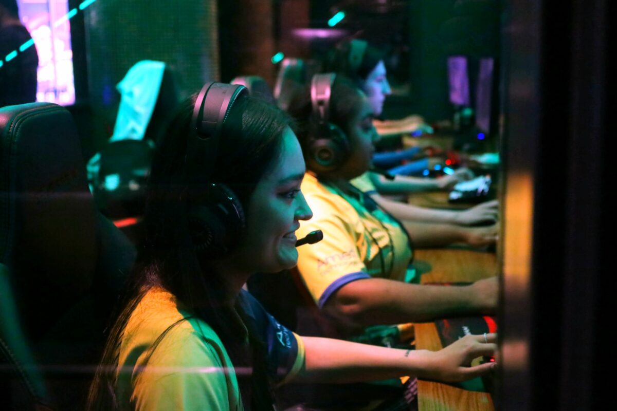 Female gamers are shown in front on their gaming setups. (Credit: Pace University)