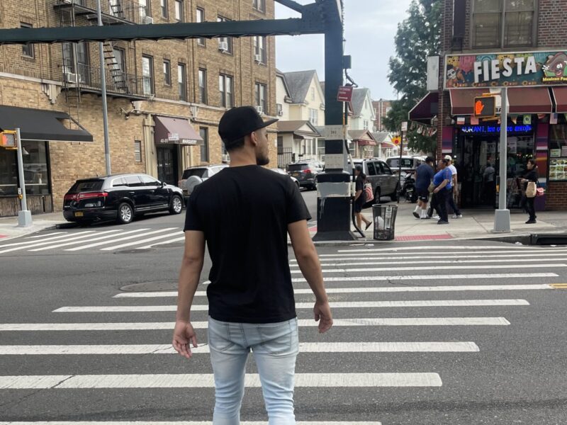 Henderson Sosa walking across Roosevelt Avenue, in Queens, trying to find a business in the neighborhood that could offer him a job. (Credit: Gabriela Henriquez)
