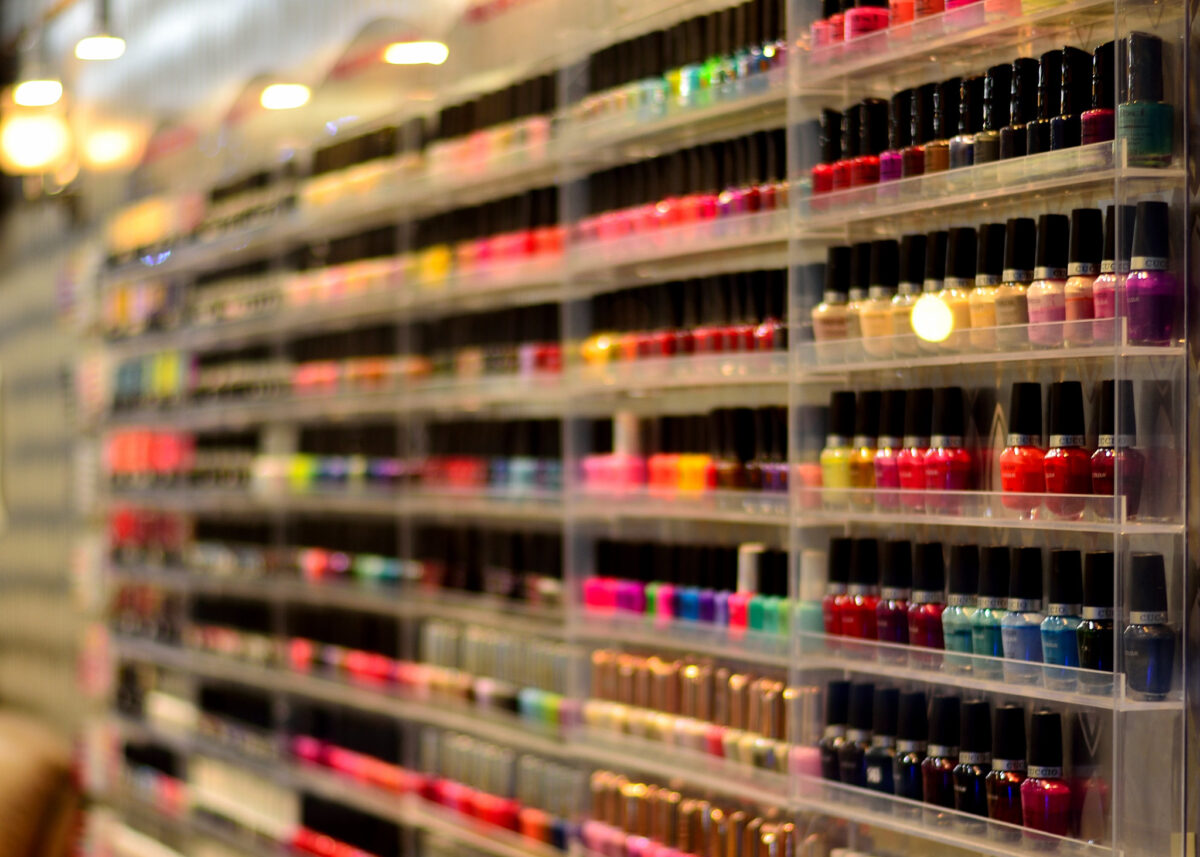 Nail polish of different colors is displayed on the wall. Credit: Tom Hilton