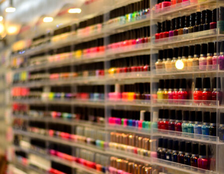 Nail polish of different colors is displayed on the wall. Credit: Tom Hilton
