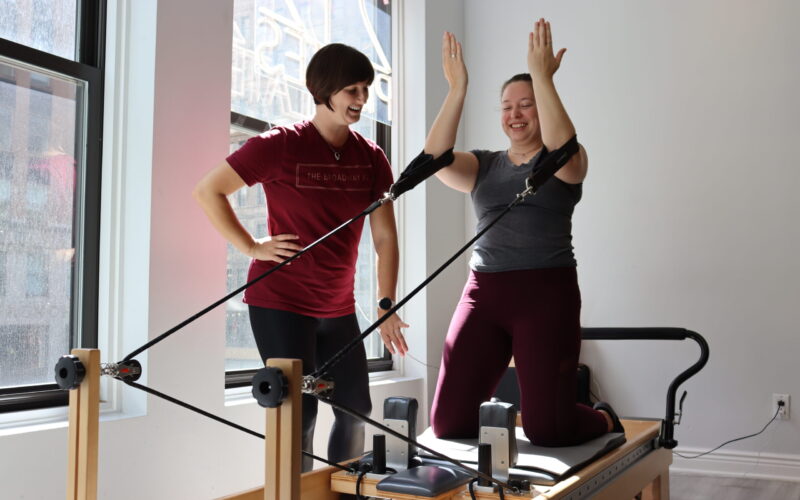 Performing-arts physical therapist Megan Wise assists her patient, Megan Groh, in completing strength and flexibility exercises Sept. 19. Wise primarily works with dancers, theater performers and backstage workers like Groh, a Broadway wardrober. (Credit: Sarah Komar)