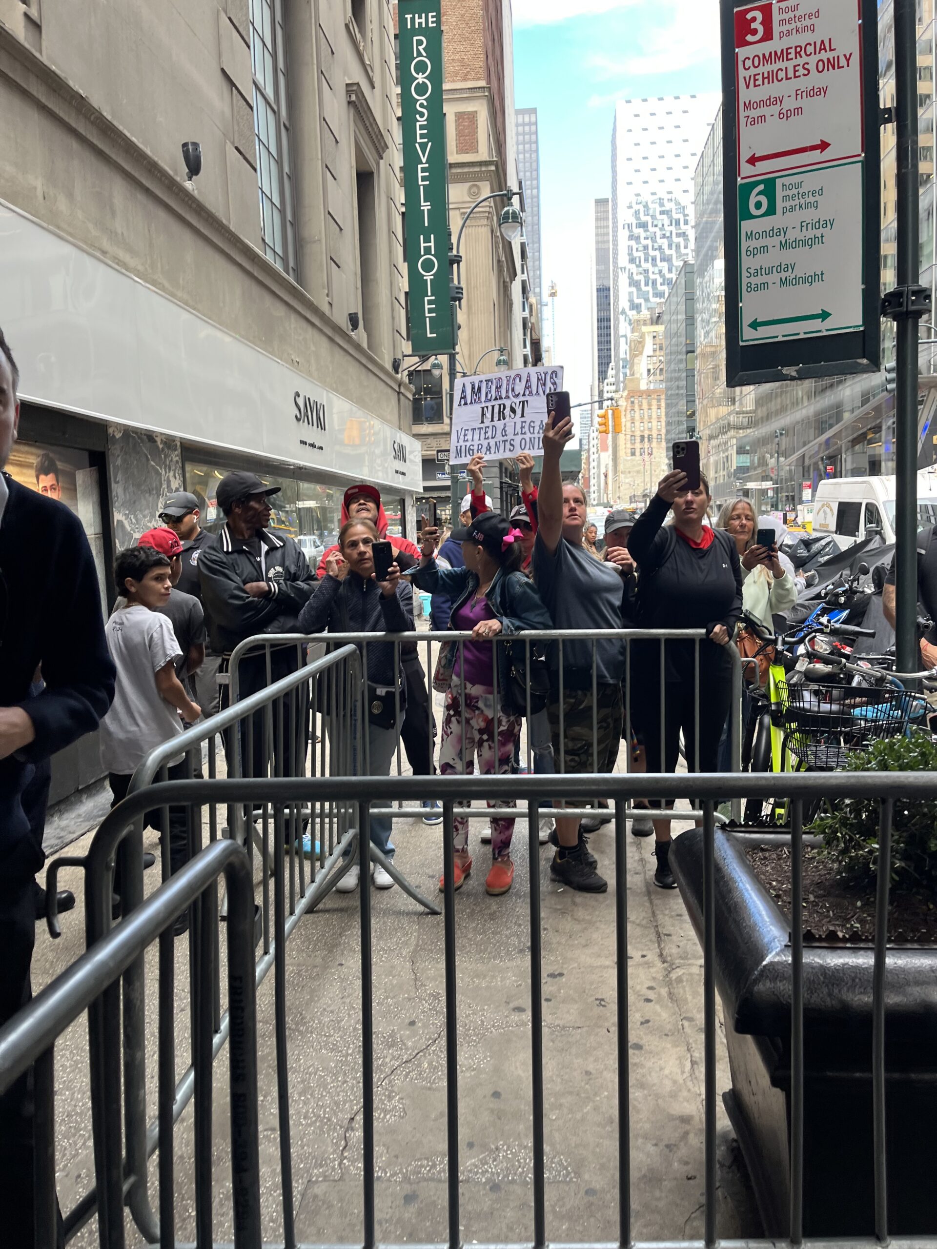 Anti-immigration protestors shout over Rep. Alexandria Ocasio-Cortez’s speech at the Roosevelt Hotel migrant shelter. (Credit: Ottilie Mitchell)