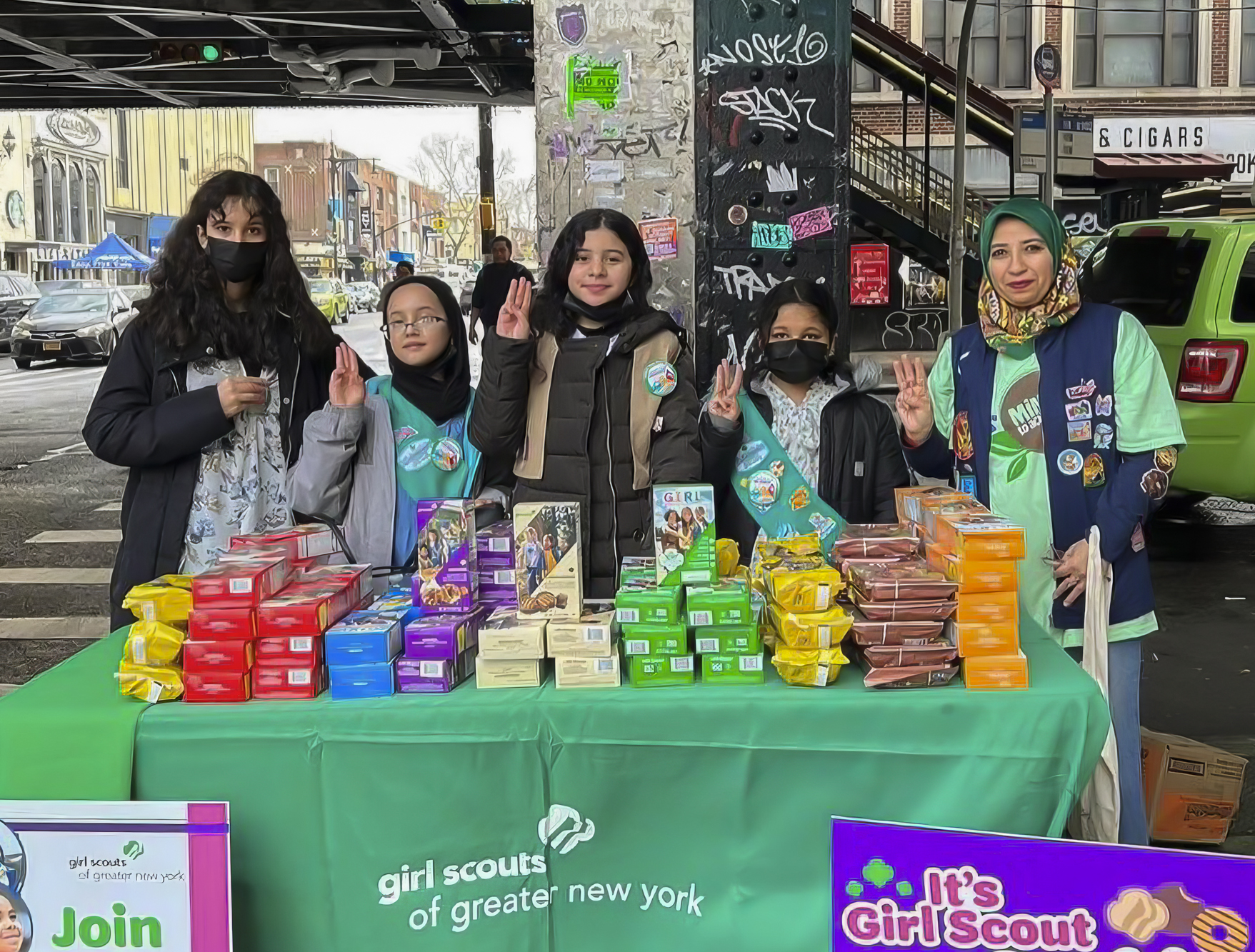Rayan assists members of the Muslim Girl Scouts of Astoria in annual cookie sales. (Credit: Photo courtesy of The Muslim Girl Scouts of Astoria, Instagram).