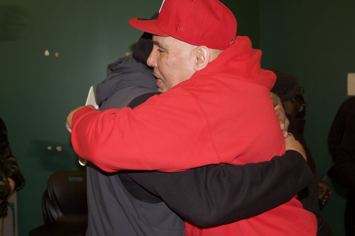Edwin Ortiz and a member of the Returning Citizens Support Group hug during a session.(Credit: Indy Scholtens)