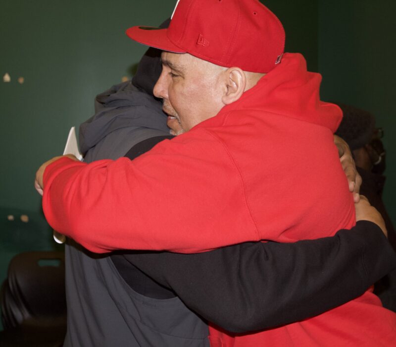 Edwin Ortiz and a member of the Returning Citizens Support Group hug during a session.(Credit: Indy Scholtens)