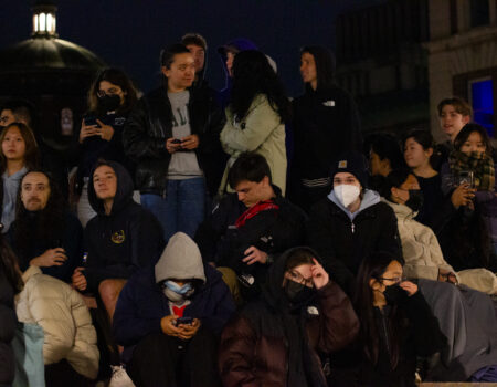 People watch demonstrators from the sundial at College Walk on Columbia's campus. (Credit: Edward Lopez)