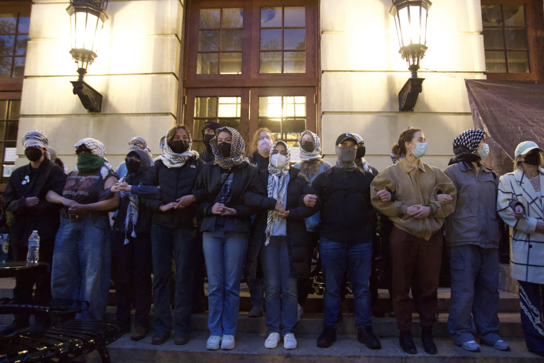 Protesters lock arms in front of Hamilton Hall on April 30, moments before the police sweep in at Columbia University. (Credit: Indy Scholtens)