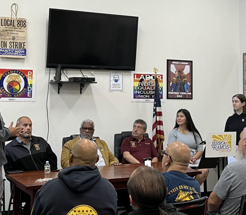 Antonio Rosario (left) speaks about Teamsters Local 804’s endorsement of State Sen. Jessica Ramos (second from the right) at a union event on Oct. 8. (Credit: Eleanor Hildebrandt)