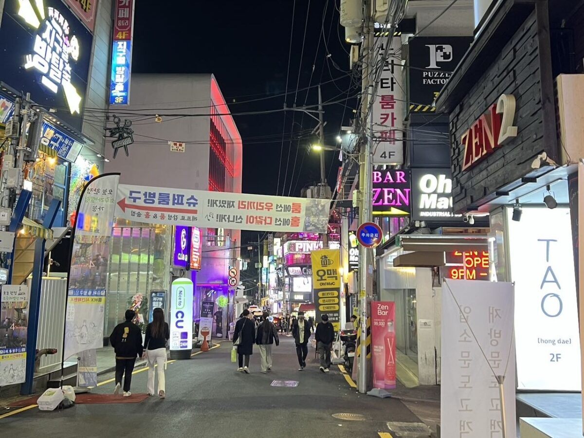 Bright neon lights illuminate a lively street in Hongdae, Seoul. (Credit: Cindy Shan)