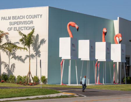 A 30-foot sculpture of flamingos and voting booths created by a native New Yorker stands outside a Florida elections office. (Credit: Robin Hill)