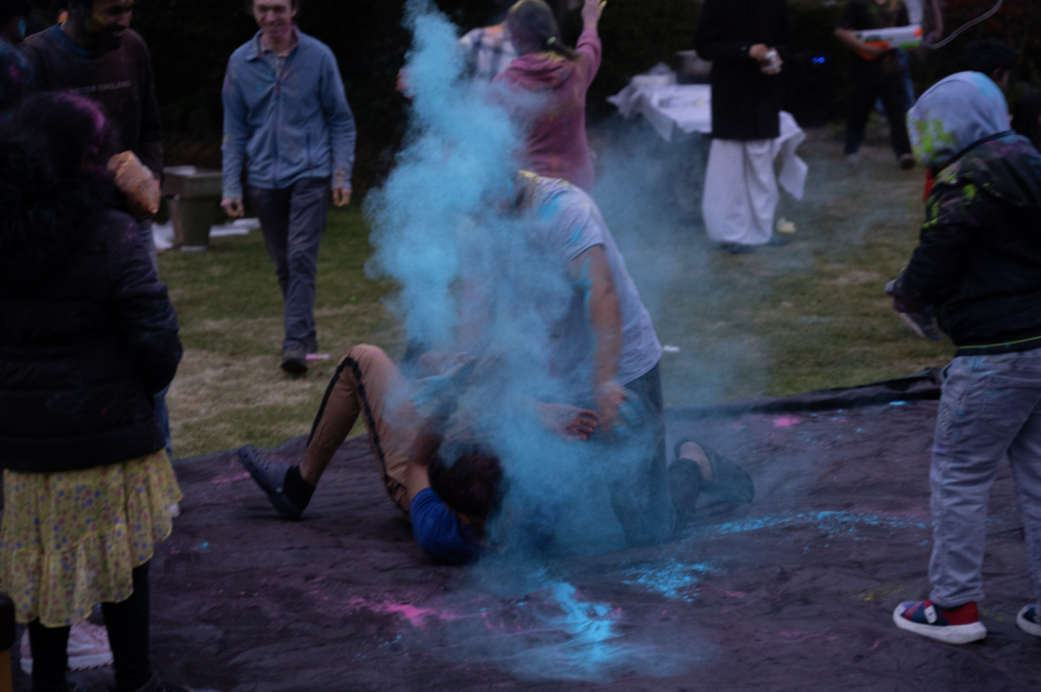 Devotees at ISKCON Belfast play on the tarp, throwing handfuls of a powder called ‘color’ at each other at a Holi Celebration on March 17. (Credit: Laine Immell)