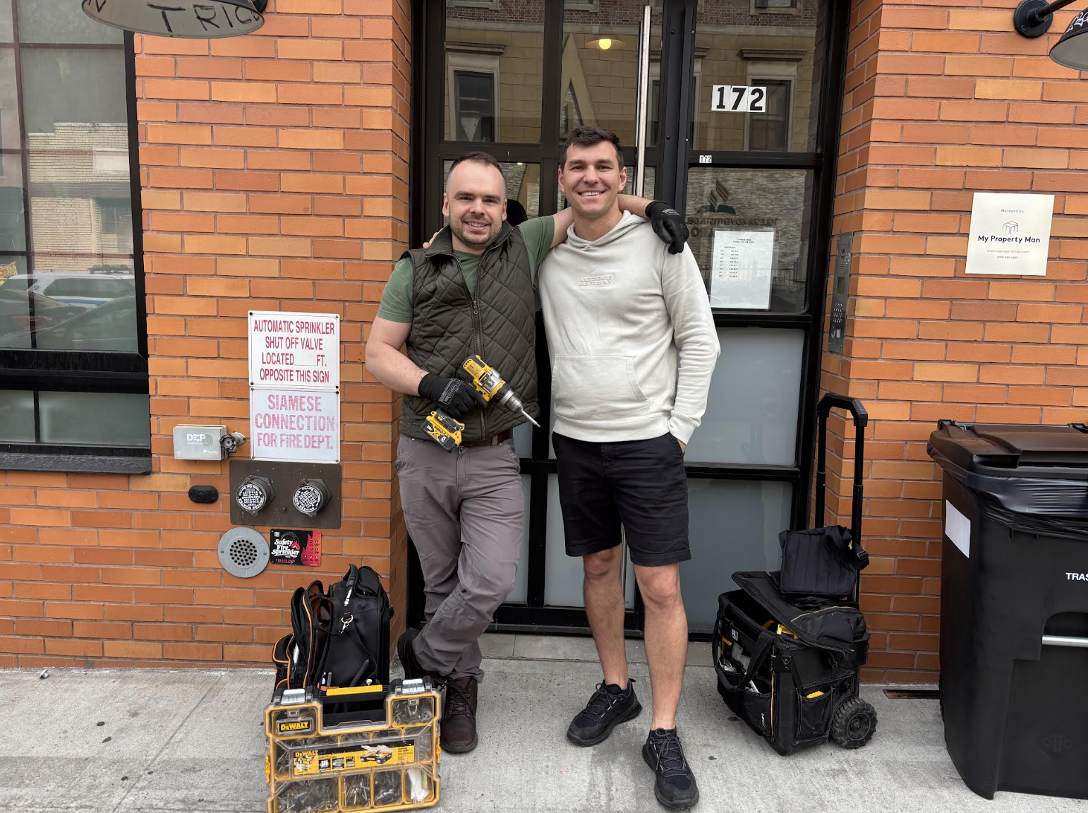 Pidneybennyi and Drach pose after installing a J-bar in Bushwick. (Credit: Lauren Hartley)