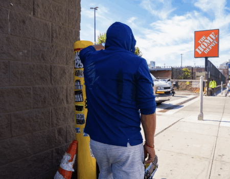 A day laborer waits for a potential employer outside a Home Depot in Queens. (Credit: Alonso Vidal)