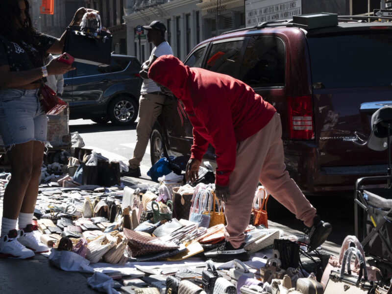 A street vendor lays out goods on Broadway in Manhattan, Sep. 20, 2025. (Credit: David Pinto)