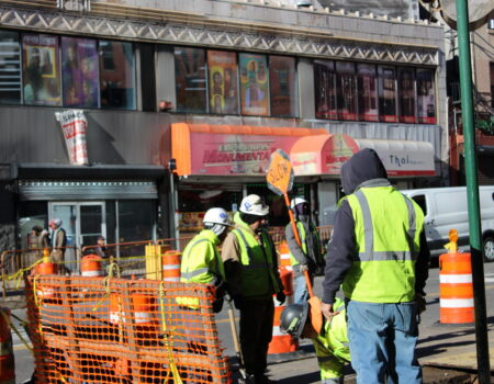 Construction workers operate equipment at a work site in Manhattan. (Credit: Anna Lee)