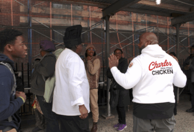 Charles Gabriel (left), the founder of Charles Pan-Fried Chicken, and Chief Operations Officer Chef Quie Slobert (right) chat with people in line for free meals at Saint Joseph’s Church in Harlem. (Credit: Anna Lee)