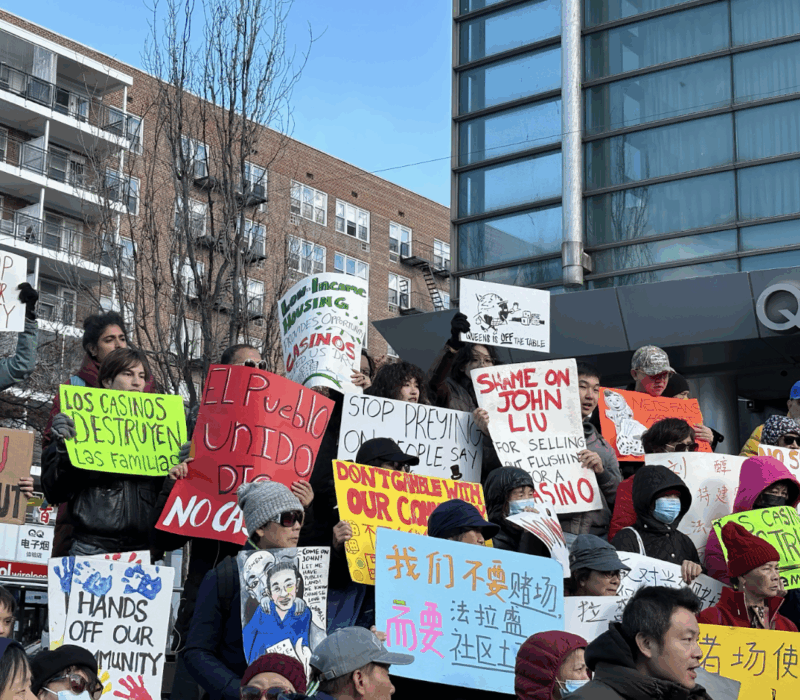Demonstrators held signs on the Queens Library Steps on Nov. 16. (Credit: Olivia Morrison)