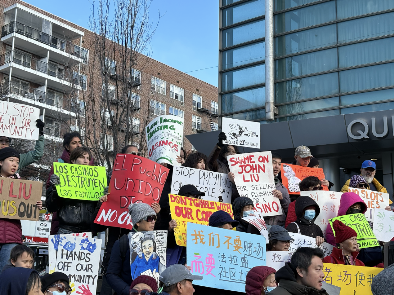 Demonstrators held signs on the Queens Library Steps on Nov. 16. (Credit: Olivia Morrison)