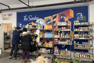 A volunteer at Greater Goods assists a patron. (Credit: Kathryn Rice)