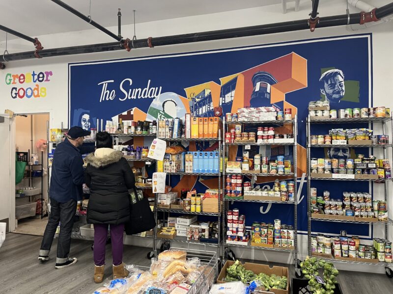 A volunteer at Greater Goods assists a patron. (Credit: Kathryn Rice)