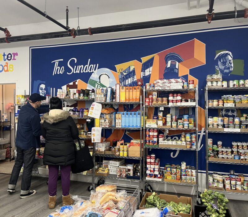 A volunteer at Greater Goods assists a patron. (Credit: Kathryn Rice)