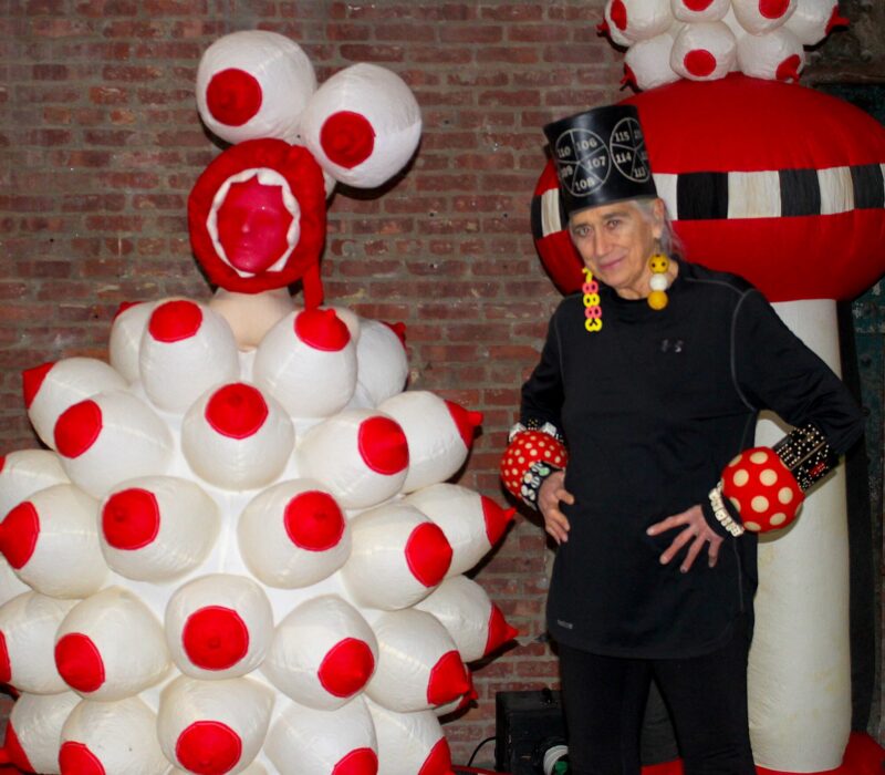 Pat Oleszko poses beside one other inflatable sculptures at the SculptureCenter in Queens (Credit: Anna Lee)