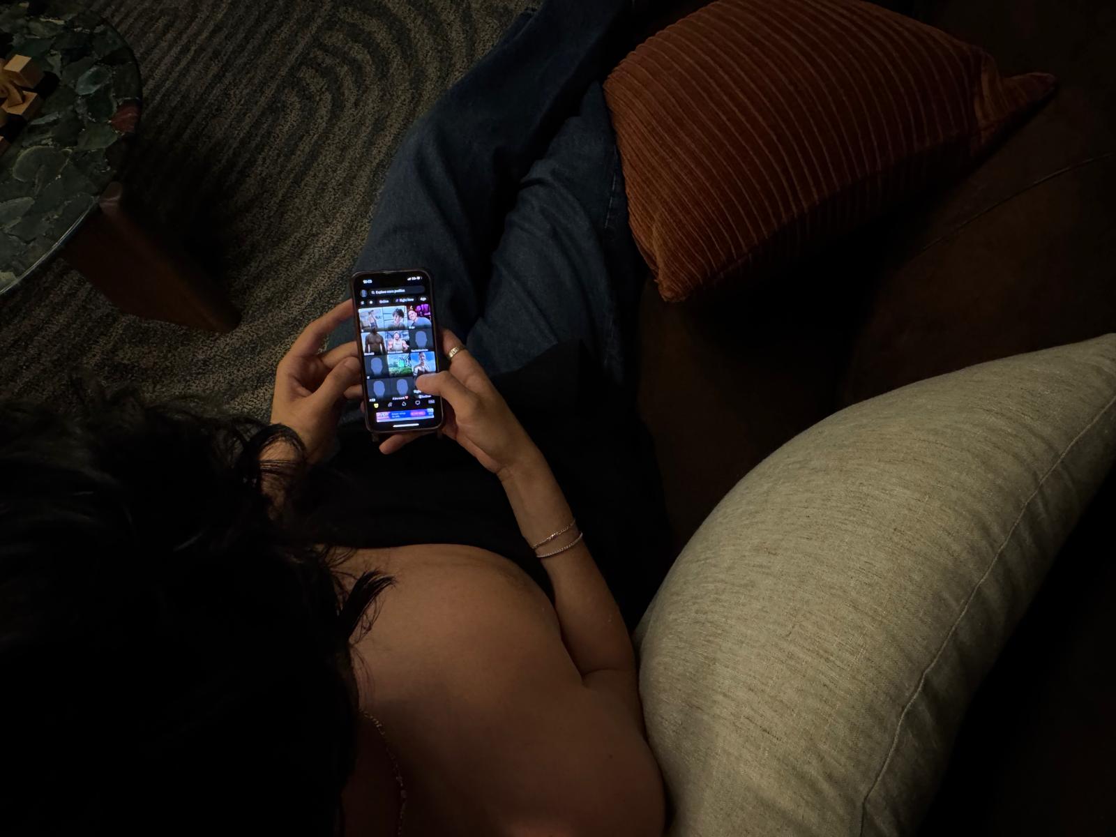 A man scrolls on Grinder. (Credit: Alix Coutures)
