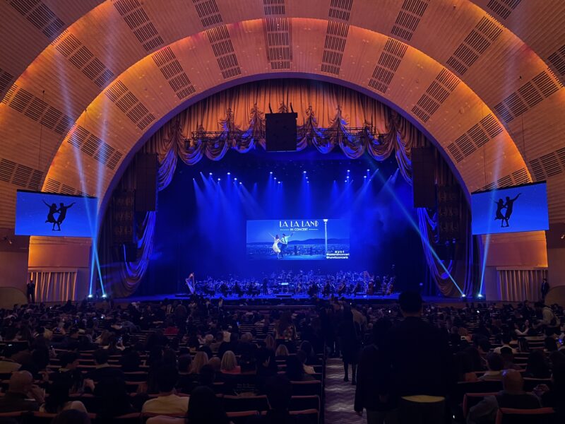 Under composer Justin Hurwitz’s baton, a full orchestra and jazz ensemble accompany a screening of La La Land at Radio City Music Hall. (Credit: Crystal Hu)