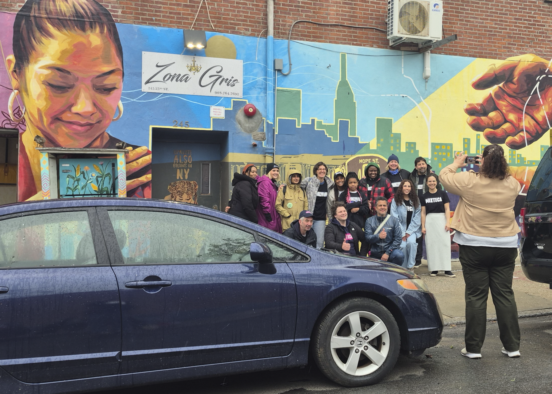 Volunteers from Mixteca Organization, Inc., and Brooklyn Org pose for a photo in Sunset Park after their weekly market offering free produce to Brooklyn's Latino community. (Credit: Sophia Ramirez)