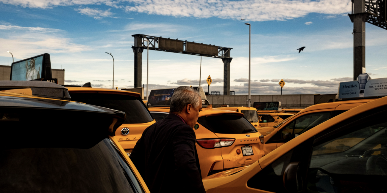 Norman Buenvaentura stands beside his taxi. (Credit: Liam Kennedy)