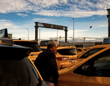 Norman Buenvaentura stands beside his taxi. (Credit: Liam Kennedy)