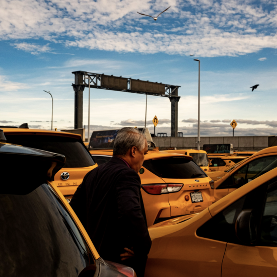 Norman Buenvaentura stands beside his taxi. (Credit: Liam Kennedy)