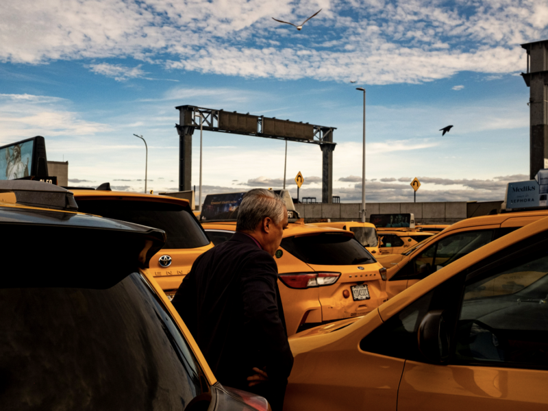 Norman Buenvaentura stands beside his taxi. (Credit: Liam Kennedy)