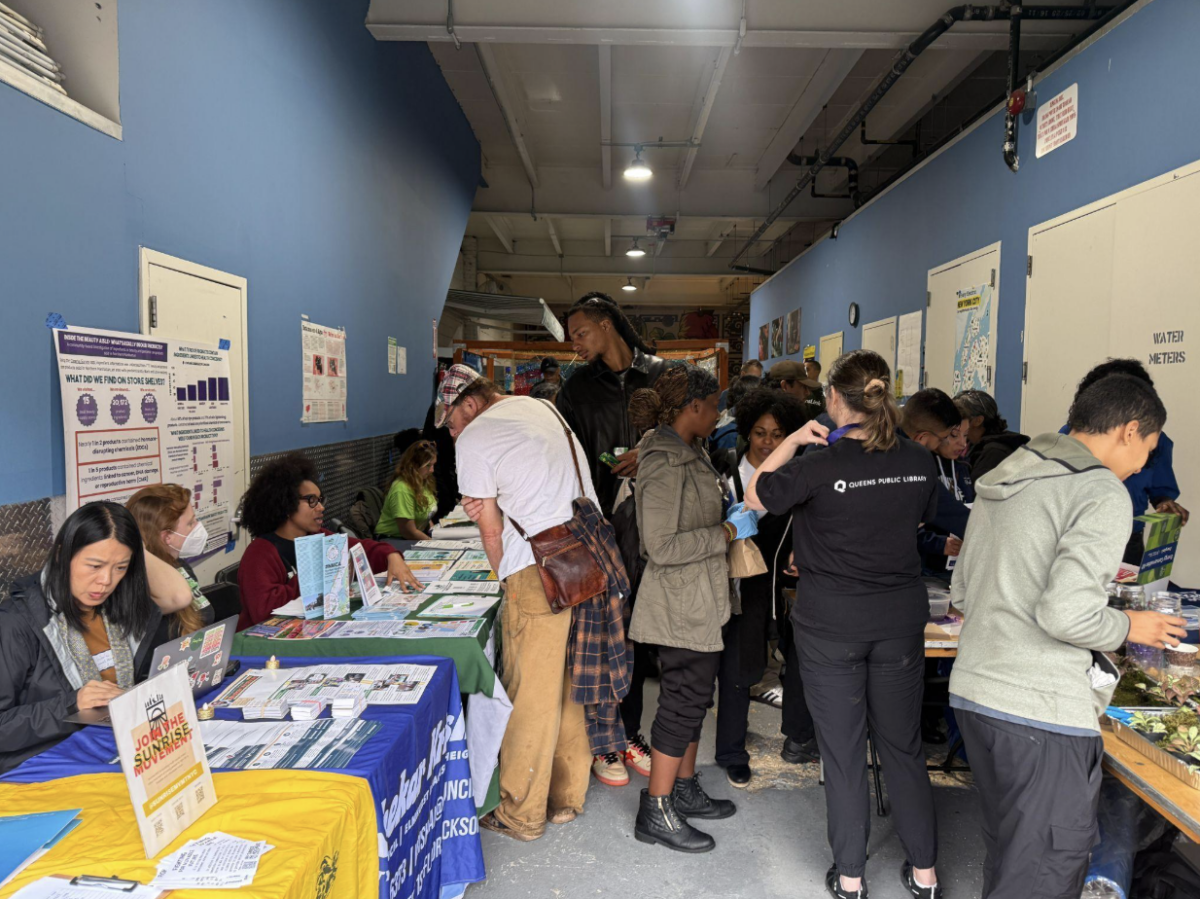 Attendees gather around tables at Street Works Earth at Connected Chef in Woodside on Sept. 27, 2026. The annual climate and arts festival moved indoors after forecasts of a nor’easter forced organizers to abandon plans to hold the event on the 34th Avenue Open Street in Jackson Heights. (Credit: Daniel Rivero Alvarez)