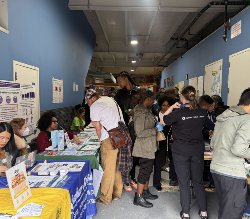 Attendees gather around tables at Street Works Earth at Connected Chef in Woodside on Sept. 27, 2026. The annual climate and arts festival moved indoors after forecasts of a nor’easter forced organizers to abandon plans to hold the event on the 34th Avenue Open Street in Jackson Heights. (Credit: Daniel Rivero Alvarez)
