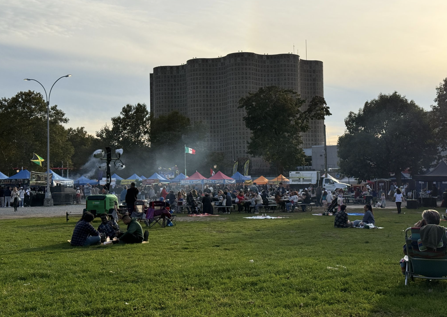 The Queens Night Market sits behind the New York Hall of Science in Flushing Meadow Corona Park. Thousands of people pour in and out every week enjoying food from nearly 100 different countries. (Credit: Karla Perez)