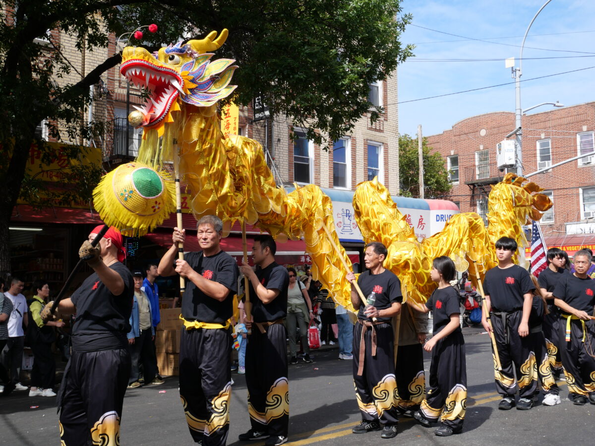 The parade featured a dragon dance troupe, shown marching down 8th Avenue. (Credit: Kim Nguyen)