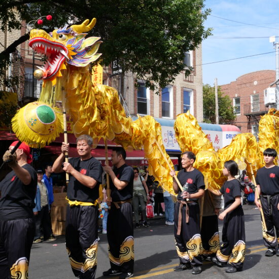 The parade featured a dragon dance troupe, shown marching down 8th Avenue. (Credit: Kim Nguyen)